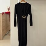 Gold buckle accented long sleeve black midi dress