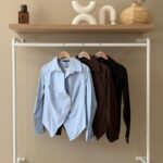 Asymmetrical gold button shirt