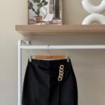 Gold chain detail mini black skirt