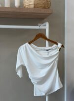 One shoulder drape white top with gold hardware